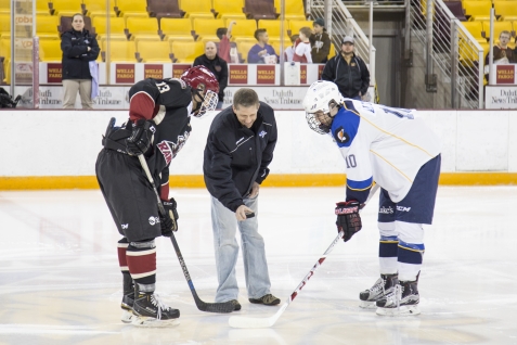 Dr. John Watkins, St. Luke's orthopedic surgeon, drops the ceremonial puck for the 2016 High School All Star Hockey Game